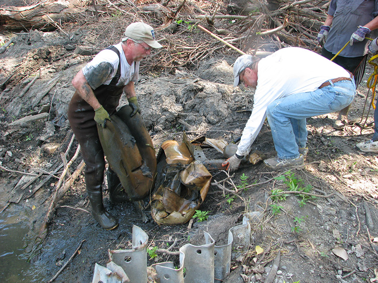 Rouge volunteers remove debris from the floodplain.